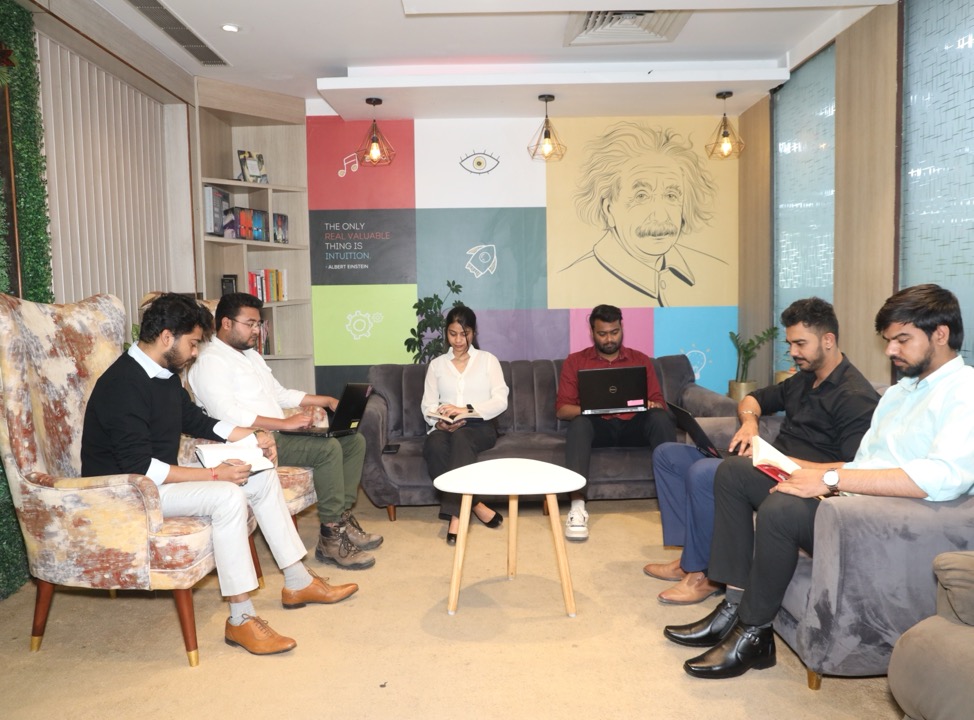 ReachIQ lounge — team collaborating around the Einstein wall